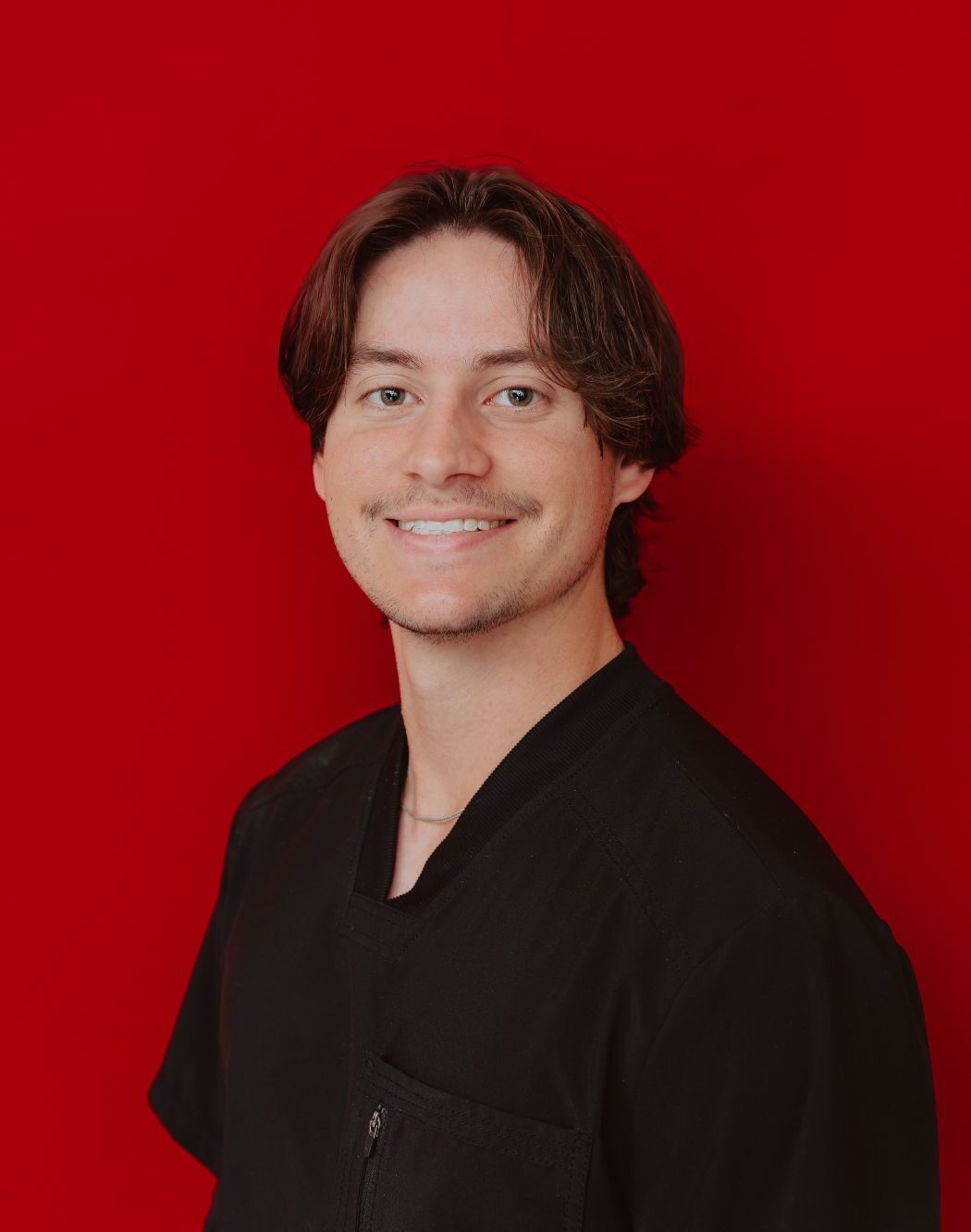 Boston Melton, Records Technician at Sparkman Orthodontics, smiling in professional attire.