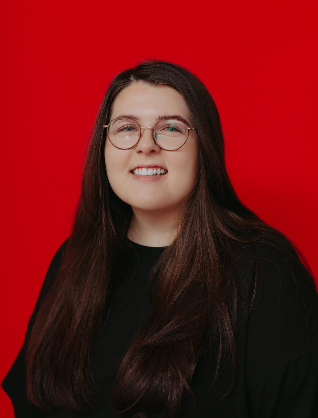 Tatum Erickson, Sparkman Orthodontics Patient Care Center team member, smiling and wearing glasses.